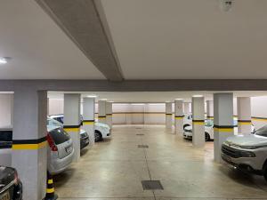 a parking garage with cars parked in it at Hotel Seven in Goiânia