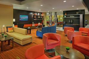 a waiting room with colorful chairs and tables at Courtyard Philadelphia Coatesville Exton in Coatesville