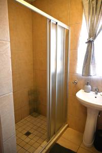 a bathroom with a shower and a sink at Summersun Village in Parys