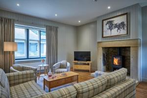 a living room with a couch and a fireplace at The Filly in Hexham