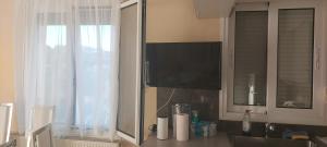 a kitchen with a sink and a tv and a window at Billy's apartments in Artemida +28 photos