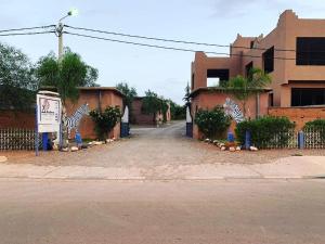 a fence with zebras on the side of a street at Camping Auberge Zebra in Ouzoud