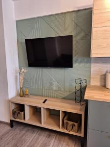 a flat screen tv hanging on a wall at CITADEL VIEW in Târgu Neamț