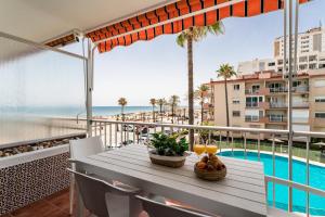- une table sur un balcon avec vue sur l'océan dans l'établissement Sur Suites Porlamar, à Fuengirola