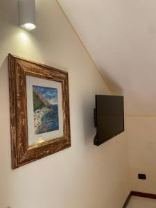 Uma TV ou centro de entretenimento em Bed & Breakfast Casa Anna Rita