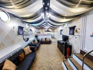 a living room with couches and a ceiling at Titanic Boat in Liverpool
