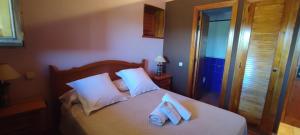 a bedroom with a bed with two towels on it at Posada de Serrada in Serrada de la Fuente