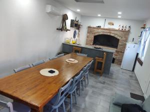 a dining room with a wooden table and a fireplace at Fjaka 