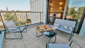 a balcony with a bed and a table and chairs at Keystone Boutique H&ocirc;tel in Lyon