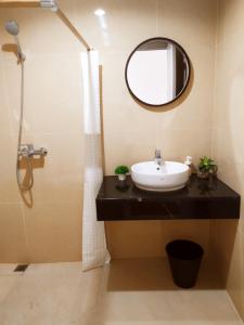 a bathroom with a sink and a mirror at DeAr Caspian Apartment in Surabaya