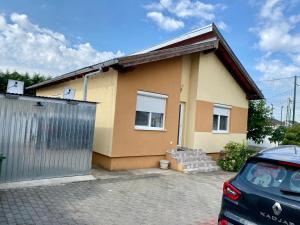 a house with a car parked in front of it at “Home sweet home” in Sîntandrei