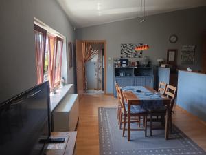 a kitchen and dining room with a table and chairs at Ferienwohnung Mattheiser Weiher in Trier