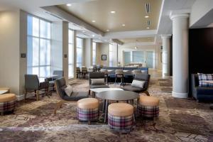 a lobby with tables and chairs and a waiting room at Residence Inn by Marriott Fairfax City in Fairfax