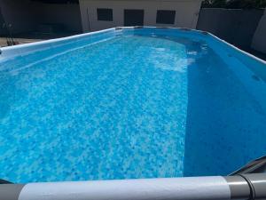 a large blue swimming pool with blue water at Apartman Žanić Ogulin with pool and jacuzzy in Ogulin