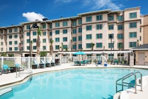 a pool in front of a large apartment building at Residence Inn by Marriott Near Universal Orlando in Orlando