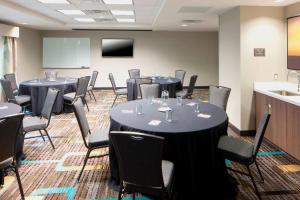 a conference room with tables and chairs and a screen at Residence Inn by Marriott Near Universal Orlando in Orlando +38 photos