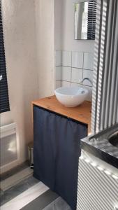 a bathroom with a sink and a white bowl at Studio au centre de Quimper RDC in Quimper