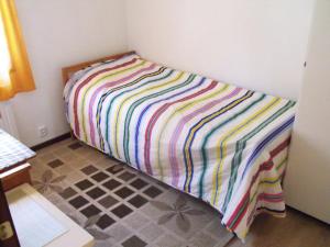 a bed in a room with a colorful blanket at Holiday house in Grythem, Orebro, within walking distance to lake in Örebro