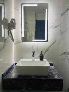 a bathroom with a white sink and a mirror at Meridiani Taksim Hotel in Istanbul