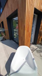 a white object is sitting on a balcony with windows at Villa Olimpijska 2 - Centrum in Wisła