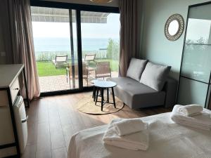 a bedroom with a bed and a view of the ocean at Kabakum Holiday Houses in Golden Sands