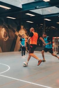 a group of men playing with a soccer ball at Next House Copenhagen in Copenhagen