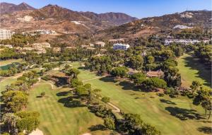 an aerial view of a golf course with mountains in the background at 2 Bedroom Gorgeous Apartment In Marbella in Marbella