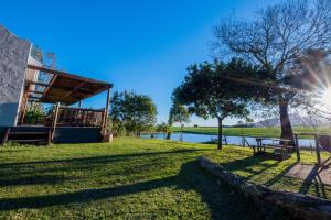 a view of a park with a bench and a lake at Boscia Farmstay in George