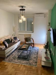 a living room with a couch and a table at Apartman JR2020 in Sarajevo