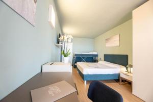 a small bedroom with a bed and a table at Hotel Baia Imperiale in Campo nell'Elba