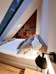 a bed in a room with a large window at Bobrowa Ostoja in Łukta +64 photos