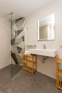 a bathroom with a sink and a shower at The Garden Palace Umag by Locap Group in Umag