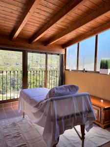 a bedroom with a bed and a large window at Hotel Casa Palacio in Montanejos
