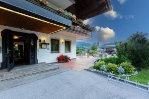 a house with a porch and a patio at Panorama Hotel CIS - bed and breakfast in Kartitsch