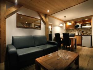 a living room with a couch and a table at Modern apartment located in the extensive Paradiski ski area in Arc 2000