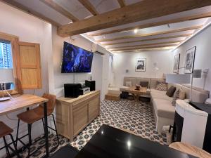 a living room with a couch and a tv at Casa Kai Altea - Torre de Bellaguarda in Altea