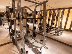 a gym with a rack of weights at Luxury 3BR with Burj Khalifa Views, Pool, Gym, and Free Parking in Dubai