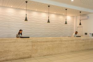 two women sitting at a counter in a lobby at Atlantica Callisto in Ayia Napa