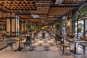 a rendering of a restaurant with tables and chairs at Unique Club at Lopesan Costa Meloneras Resort in Maspalomas