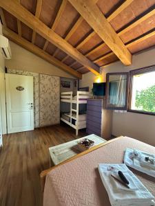 a bedroom with a bed and a room with a bunk bed at CA' DEI GELSI B & B in Coriano