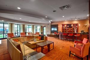 a lobby with couches and chairs and a bar at Courtyard Wall at Monmouth Shores Corporate Park in Wall Township