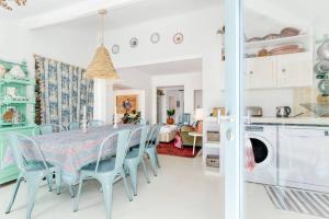a kitchen and dining room with a table and chairs at CasaCactusMelides - main house and studio in Melides