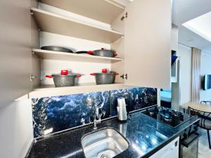 a kitchen with a sink and a counter top at Kemer Sunrise Suit in Kemer +20 photos