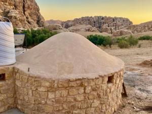 a stone building in the middle of a desert at Pink city cottage in Wadi Musa