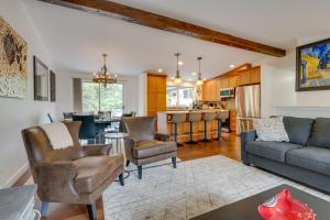 a living room with a couch and chairs and a kitchen at Kenmore Retreat with Shared Hot Tub - 1 Mi to Lake! in Kenmore