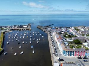 an aerial view of a harbor with boats in the water at Hive Townhouse in Aberaeron