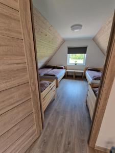 a room with four bunk beds in it at Žaliūkių pirtis in Žaliukai