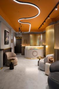 a lobby with couches and chairs and a bar at Oborishte 63,The Art Boutique Hotel by Sandglass in Sofia