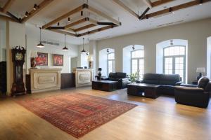 a large living room with couches and a rug at GRAND HOTEL GYUMRI by APRICOT Hotels in Gyumri