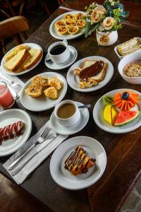 a table with plates of breakfast foods and coffee at Hotel Rotorua inn Fortaleza - Beira Mar in Fortaleza